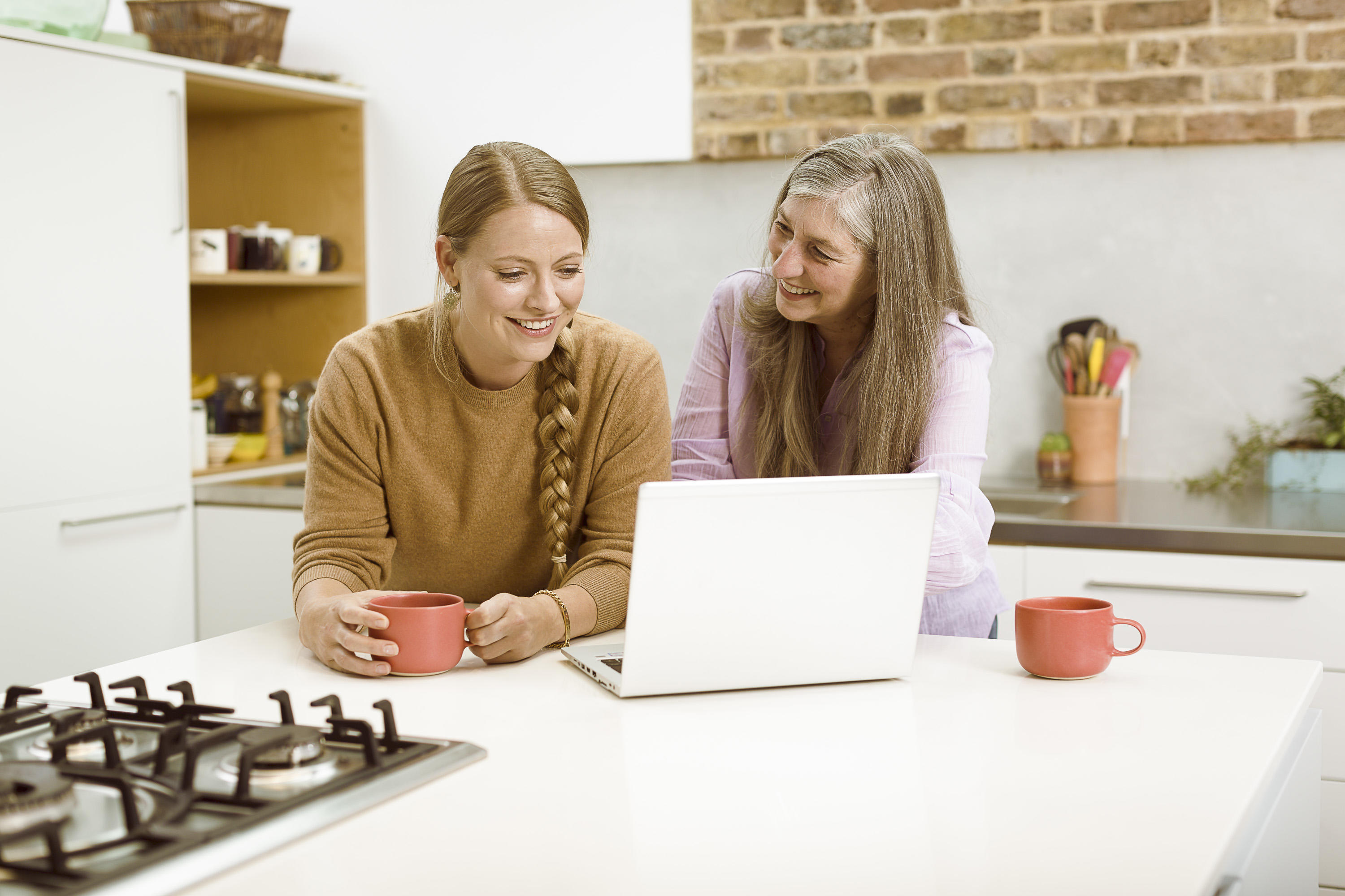 Women laptop kitchen research smiling